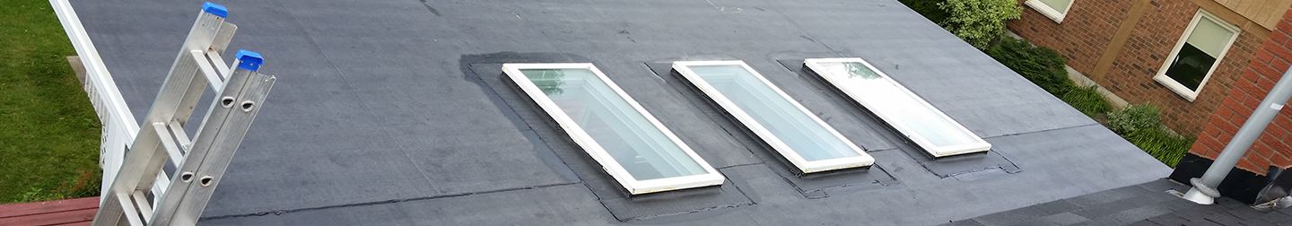 Low slope roof with three skylights